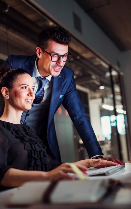 young-business-people-in-an-office-at-night-using-2024-10-21-04-04-39-utc